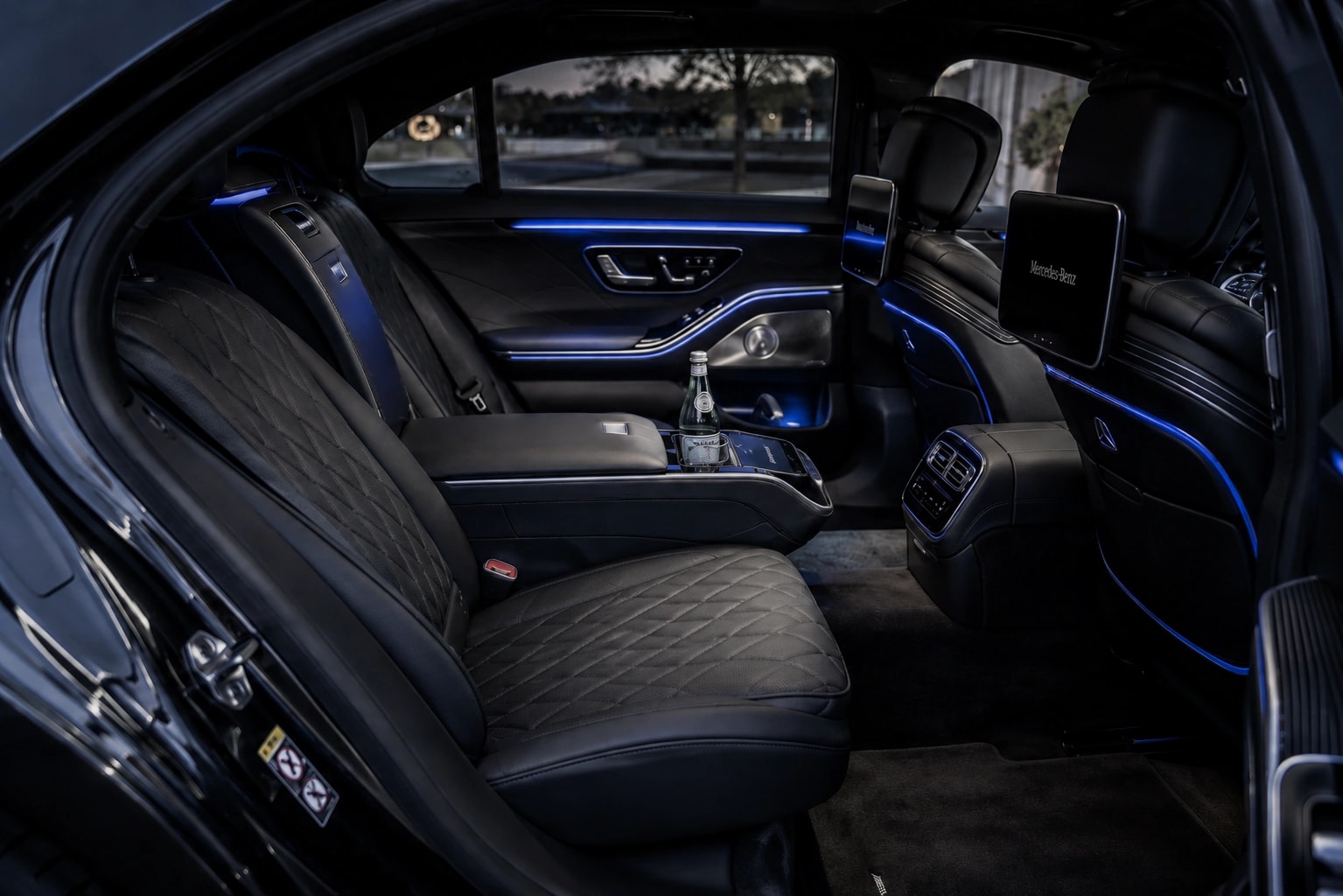 Luxury sedan interior with leather and water bottle